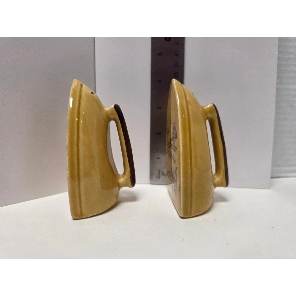vintage souvenir salt and pepper shakers like marigold yellow iron